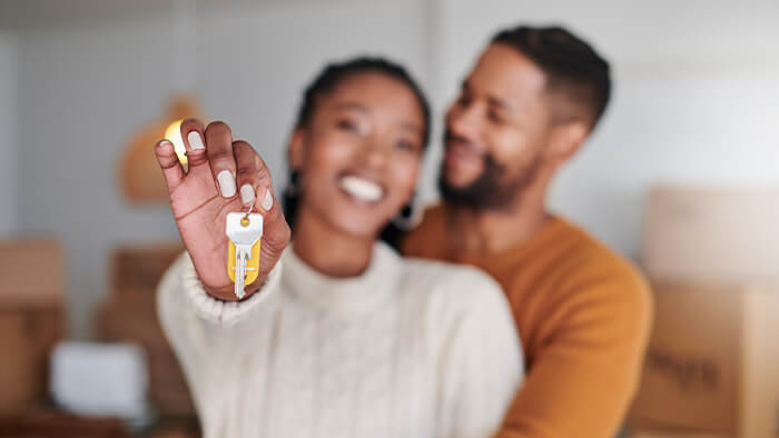 black couple holding house key AHWD
