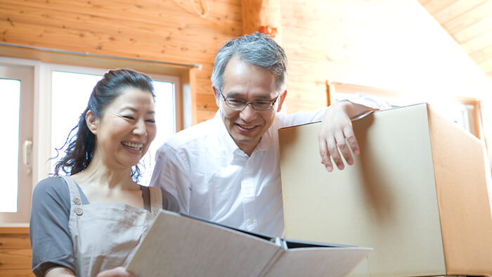 older asian couple moving into a new home AHWD