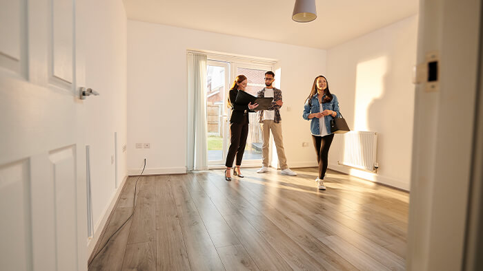 young couple viewing a home with agent ABR